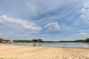 a person standing on a beach with a kite at Het Appense veld in Klarenbeek