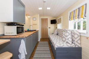 a kitchen with a couch in a tiny house at Elsie's Retreat in Durham