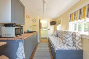 a kitchen with a couch in a tiny house at Elsie's Retreat in Durham