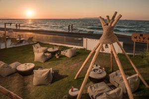 a gazebo with chairs and tables on the beach at Enorme Maya Beach Hotel-Adults Only in Gouves +31 photos
