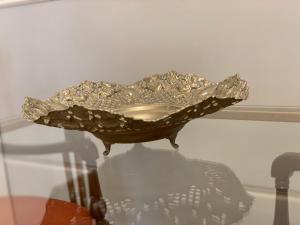 a metal bowl on a glass table with its reflection at SUITES SAN ESTEBAN 16 Real in Seville