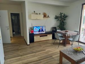 a living room with a table and a tv in it at Villa Lucija in Veles