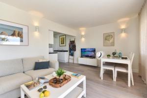 ein Wohnzimmer mit Sofa und Tisch in der Unterkunft Bungalow San Agustin Rocas Rojas by VillaGranCanaria in San Agustín