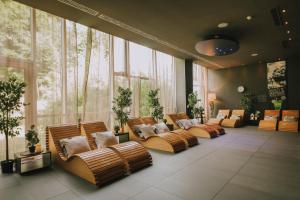 a row of brown chairs in a room with large windows at Standard Apartments Terme Sveti Martin in Sveti Martin na Muri