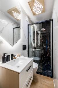 a bathroom with a white sink and a shower at Aparthome Tatra in Biały Dunajec
