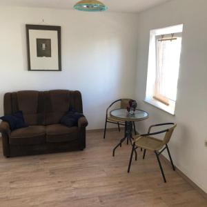 a living room with a couch and a table at Pension Rudolph Riesa in Riesa