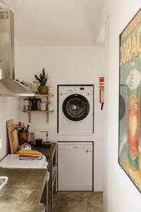 a laundry room with a washer and a washing machine at Casa da Maria • Natural Côte • Aljezur in Maria Vinagre