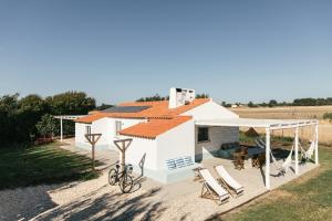a villa with a swimming pool and a house at Casa da Maria • Natural Côte • Aljezur in Maria Vinagre