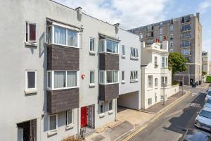 an apartment building with balconies on a city street at Beachside Retreat 2-Bedroom Gem with FREE Private Parking & Outdoor Space in Brighton & Hove