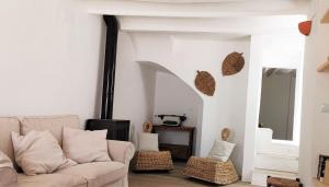 a living room with a couch and a fireplace at Casa El Olmo de Navajas in Navajas