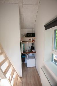 eine kleine Küche mit einem Waschbecken in einem kleinen Zimmer in der Unterkunft Tórshavn Apartment - City Center in Tórshavn