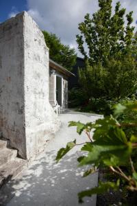 a stone wall next to a house at Tórshavn Apartment - City Center in Tórshavn +30 photos