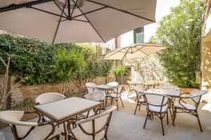 an outdoor patio with tables and chairs and umbrellas at Residenza Centopietre - Dorsoduro in Venice