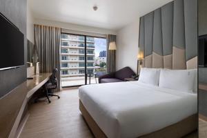 a hotel room with a large bed and a desk at Holiday Inn Express Bangkok Sukhumvit 11, an IHG Hotel - Free Breakfast in Bangkok