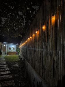 a row of lights on a wall at night at The Backyard Glamp - Book The Entire Campground 
