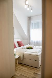 a bedroom with a bed and a window at Rose Gold Apartment in Zalaegerszeg