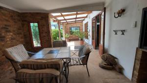 a dining room with a table and chairs at Bluebell Barn in Dullstroom