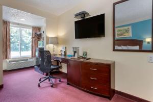 an office with a desk and a chair and a mirror at Rodeway Inn & Suites New Paltz- Hudson Valley in New Paltz