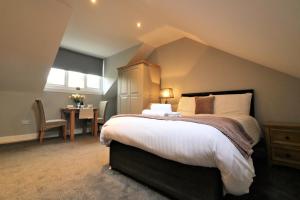 una camera da letto con un letto grande e un tavolo di Signature - Linden Cottage Room 3 ad Airdrie