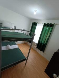 a room with two bunk beds and a window at Alles One Oasis Condo Davao Near SM Mall with Wifi in Davao City