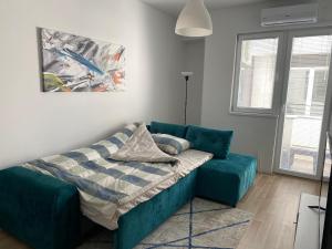 a living room with a couch and a bed at Old Bazaar Apartment with Private Parking in Skopje