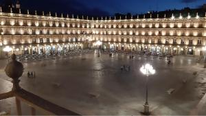 a large building with lights in a courtyard at night at Plaza Mayor Salamanca in Salamanca