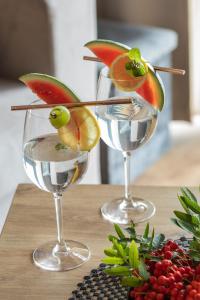 two wine glasses with fruit on top of a table at Apartamenty Jantaris SeaView by Renters in Mielno