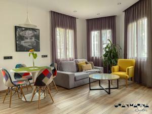 ein Wohnzimmer mit einem Sofa und einem Tisch in der Unterkunft Gran Marina Suites in Las Palmas de Gran Canaria