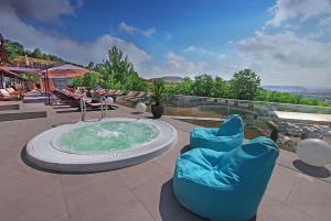 a hot tub sitting on top of a patio at Complex Turistic Creanga Resort & Spa in Tîrgu Ocna