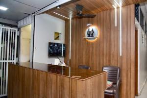 an office with a desk and chairs and a mirror at Nivant Lodge in Solapur