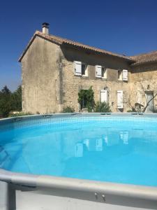 a large swimming pool in front of a house at Charente Chambres d'Hôtes - B&B in Bernac