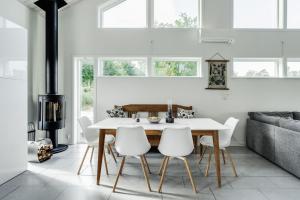 a dining room with a white table and white chairs at Luxury holiday home in Tallbacken with lake views over Bolmen in Ljungby