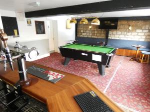 a room with a pool table in a pub at The Riverside Hotel in Monmouth