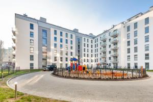 a playground in front of a large building at Apartamenty Sun & Snow Angielska Grobla in Gdańsk