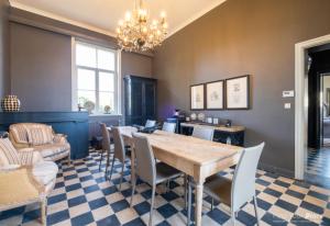 a dining room with a table and chairs at La Ragotière in Froyennes