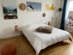 a bedroom with a bed with a pillow on it at Maison entière au calme à Saint-Max/Nancy in Saint-Max
