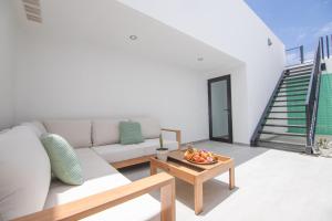 a living room with a couch and a table at Cascasas The Green Apartment in Corralejo