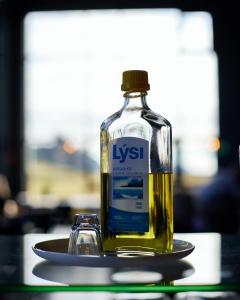 a bottle of whisky sitting on a plate with a glass at Hótel Kría in Vík