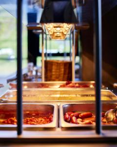 a buffet with several trays of food on display at Hótel Kría in Vík
