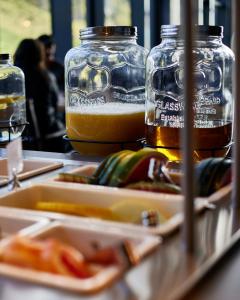 a table with two containers of food and two jars of beer at Hótel Kría in Vík