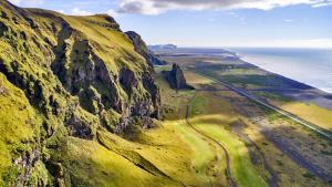 an aerial view of a mountain next to the ocean at Hótel Kría in Vík