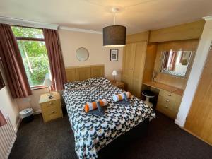 a bedroom with a bed and a desk and a window at Castlepoint in Strangford