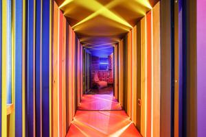 a hallway with colorful stripes on the walls of a room at HouseX in Krasnodar