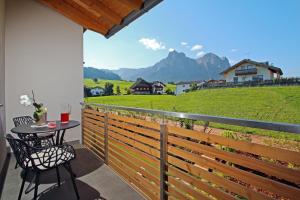 a balcony with a table and a view of a mountain at Apartments Cornelia in Castelrotto
