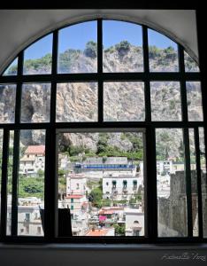 a view through a window of a city at Casa Maddy Amalfi Coast in Atrani +10 photos
