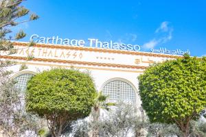 a building with a sign on the side of it at Carthage Thalasso Resort in Gammarth