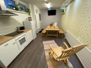 a kitchen with a table and a table and chairs at Savonlinna Rentals in Savonlinna