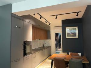 a kitchen with a table and a dining room at DAF apartaments in Pristina