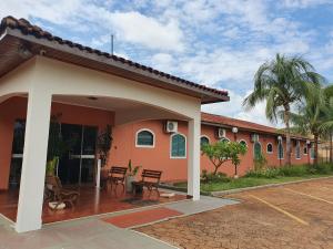 a house with a patio and a building at Hotel Recreio dos Bandeirantes in Sertãozinho