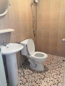 a bathroom with a toilet and a sink at Max's Beach House in Pattaya South